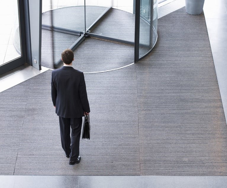 man entering a revolving door