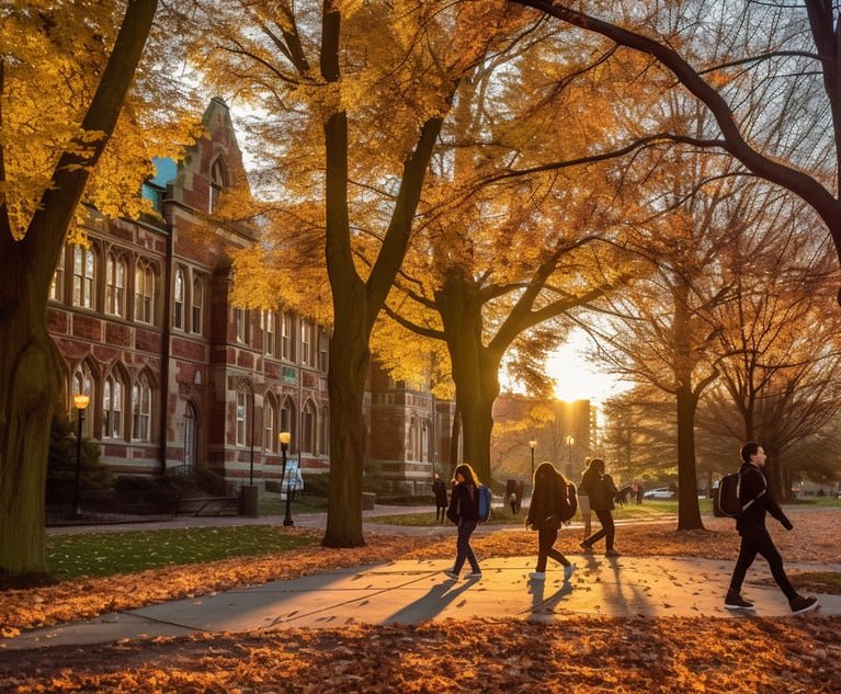 Students walking on a college campus in the fall.